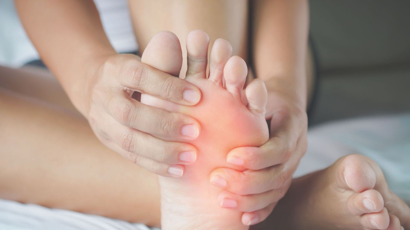 person rubbing their foot