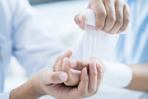 dressing being applied to wound